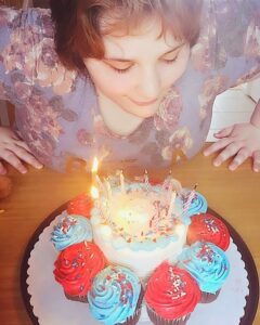 Woman blowing candles on a cake