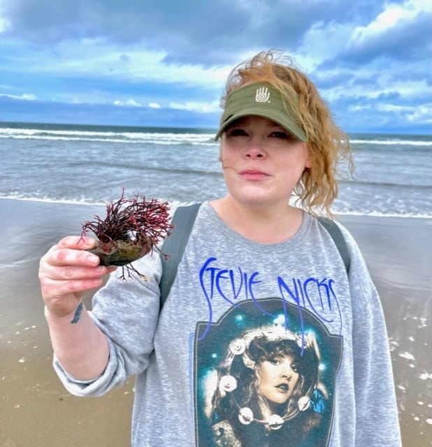 Woman holding sea plant