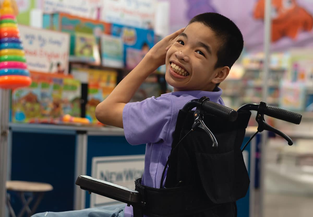 Little boy in wheelchair at school
