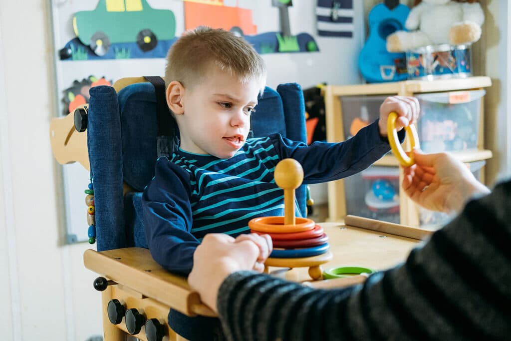 Little boy playing with toy rings